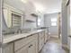 Bathroom featuring a marble countertop, tile flooring, and custom mirrors at 3437 Aspen Trl, Clearwater, FL 33761
