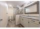 Well-lit bathroom features stone countertop vanity and glass-enclosed shower at 3437 Aspen Trl, Clearwater, FL 33761