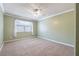 Bedroom with plush carpet and lots of natural light, featuring large window at 3437 Aspen Trl, Clearwater, FL 33761
