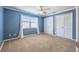 Bedroom featuring blue walls, plush carpet, white trim, and a ceiling fan at 3437 Aspen Trl, Clearwater, FL 33761