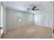 Spacious bedroom with plush carpet, a ceiling fan, and windows for natural light at 3437 Aspen Trl, Clearwater, FL 33761