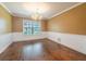 Classic dining room with decorative molding, a large window, and hardwood floors at 3437 Aspen Trl, Clearwater, FL 33761