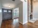 Elegant foyer featuring a brick fireplace, hardwood floors, and a grand double door entrance at 3437 Aspen Trl, Clearwater, FL 33761