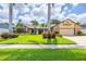 Charming home exterior with well-manicured lawn, mature landscaping, and brick-accented facade at 3437 Aspen Trl, Clearwater, FL 33761