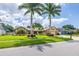 Inviting home exterior featuring lush landscaping, palm trees, and a well-maintained front yard at 3437 Aspen Trl, Clearwater, FL 33761