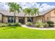 Charming home with beautiful landscaping, mature plants, and a well-manicured lawn at 3437 Aspen Trl, Clearwater, FL 33761