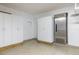 Garage with a refrigerator, white cabinets, white door and a sealed cement floor at 3437 Aspen Trl, Clearwater, FL 33761