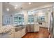 Gourmet kitchen with granite countertops, stainless steel appliances, and a large stainless steel sink overlooking the backyard at 3437 Aspen Trl, Clearwater, FL 33761