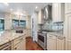 Modern kitchen featuring granite countertops, stainless steel appliances, custom cabinets, and stylish backsplash at 3437 Aspen Trl, Clearwater, FL 33761