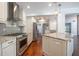 Updated kitchen featuring stainless steel appliances, granite countertops, and ample counter space at 3437 Aspen Trl, Clearwater, FL 33761