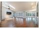 Bright living room featuring a ceiling fan, recessed lights, skylight, fireplace, and hardwood floors at 3437 Aspen Trl, Clearwater, FL 33761