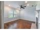 Comfortable living room with hardwood floors, a fireplace, and plantation shutters at 3437 Aspen Trl, Clearwater, FL 33761
