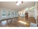 Spacious living room with French doors leading to the pool area, hardwood floors, and a brick fireplace at 3437 Aspen Trl, Clearwater, FL 33761