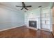 Inviting living room with a fireplace, built-in shelving, and hardwood floors at 3437 Aspen Trl, Clearwater, FL 33761