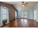 Light-filled main bedroom with vaulted ceiling, wood accent wall, and french doors to the outdoors at 3437 Aspen Trl, Clearwater, FL 33761
