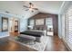Comfortable main bedroom with wood accent wall, tray ceiling, and french doors to the outdoors at 3437 Aspen Trl, Clearwater, FL 33761