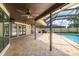 Covered patio with ceiling fans and picturesque view of the swimming pool at 3437 Aspen Trl, Clearwater, FL 33761