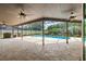Covered patio with ceiling fans and picturesque view of the swimming pool and green foliage at 3437 Aspen Trl, Clearwater, FL 33761