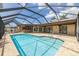 Beautiful screened-in pool with outdoor seating and updated patio perfect for entertaining friends and Gathering outdoors at 3437 Aspen Trl, Clearwater, FL 33761