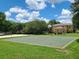 Community basketball court and sand volleyball with trees and grassy areas on a clear, sunny day at 36137 Lake Chase Blvd # 102, Zephyrhills, FL 33541