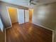 Bright bedroom featuring hardwood floors, closet and ceiling fan with overhead lighting at 36137 Lake Chase Blvd # 102, Zephyrhills, FL 33541