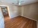 Bedroom boasting hardwood floors, a ceiling fan and access to the kitchen area at 36137 Lake Chase Blvd # 102, Zephyrhills, FL 33541