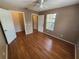 A bedroom featuring hardwood floors, a ceiling fan, and two entry doors at 36137 Lake Chase Blvd # 102, Zephyrhills, FL 33541