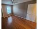 Bedroom with ceiling fan, window and wood-look laminate flooring at 36137 Lake Chase Blvd # 102, Zephyrhills, FL 33541