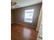 Bedroom featuring hardwood floors, a ceiling fan and a window allowing ample light at 36137 Lake Chase Blvd # 102, Zephyrhills, FL 33541