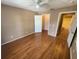 Bedroom featuring hardwood floors, ceiling fan, closet and an ensuite bathroom at 36137 Lake Chase Blvd # 102, Zephyrhills, FL 33541