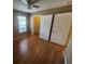 Bedroom with hardwood floors, ceiling fan, closet and natural light through the window at 36137 Lake Chase Blvd # 102, Zephyrhills, FL 33541