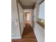 Hallway with wood floors and white doors leading to other rooms of the house at 36137 Lake Chase Blvd # 102, Zephyrhills, FL 33541