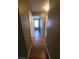 Hallway with wood floors and doors leading to other rooms at 36137 Lake Chase Blvd # 102, Zephyrhills, FL 33541