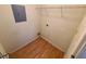 The pantry features wood-style flooring and is illuminated by overhead lighting with multiple shelves at 36137 Lake Chase Blvd # 102, Zephyrhills, FL 33541