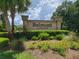 Belmont at Ryals Chase community sign featuring lush landscaping with manicured bushes and blooming flowers at 36137 Lake Chase Blvd # 102, Zephyrhills, FL 33541