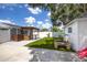 Wide backyard featuring artificial turf, a patio area, storage shed, and a modern privacy fence at 400 53Rd N St, St Petersburg, FL 33710