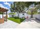Charming backyard featuring a pergola, artificial grass, and a play area perfect for outdoor entertainment at 400 53Rd N St, St Petersburg, FL 33710