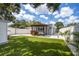 Large backyard with artificial turf, modern patio, and privacy fence at 400 53Rd N St, St Petersburg, FL 33710