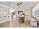 Cozy dining room featuring stylish ceiling fan, natural light, and an adjacent, fully-equipped kitchen at 400 53Rd N St, St Petersburg, FL 33710