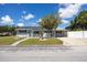 Charming single-story home with well-maintained lawn, complemented by lush landscaping and inviting curb appeal at 400 53Rd N St, St Petersburg, FL 33710