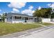 Charming single-story home with well-maintained lawn, complemented by lush landscaping and inviting curb appeal at 400 53Rd N St, St Petersburg, FL 33710