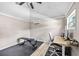 Well-lit interior features a desk, chair, workout bench, and a modern ceiling fan for year-round comfort at 400 53Rd N St, St Petersburg, FL 33710