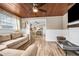 Comfortable living room with hardwood floors, wood ceilings, and plenty of natural light, and an adjacent dining room at 400 53Rd N St, St Petersburg, FL 33710
