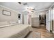 The main bedroom features a ceiling fan, closet, and an adjacent bathroom, all bathed in soft, natural light at 400 53Rd N St, St Petersburg, FL 33710