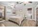 A stylish main bedroom with neutral tones, ceiling fan, and an open doorway leading to another room at 400 53Rd N St, St Petersburg, FL 33710