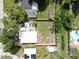 Aerial view of a home showcasing the yard, roof, and surrounding greenery at 4112 W Lawn Ave, Tampa, FL 33611
