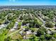 Expansive aerial view showcasing the property's location in a lush, green neighborhood with mature trees at 4112 W Lawn Ave, Tampa, FL 33611