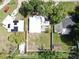Overhead view of a home with solar panels and an ample yard surrounded by mature trees and lush vegetation at 4112 W Lawn Ave, Tampa, FL 33611