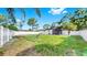 Spacious backyard surrounded by a white fence and mature trees at 4112 W Lawn Ave, Tampa, FL 33611