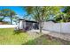 Backyard featuring a screened-in patio and lush green grass at 4112 W Lawn Ave, Tampa, FL 33611